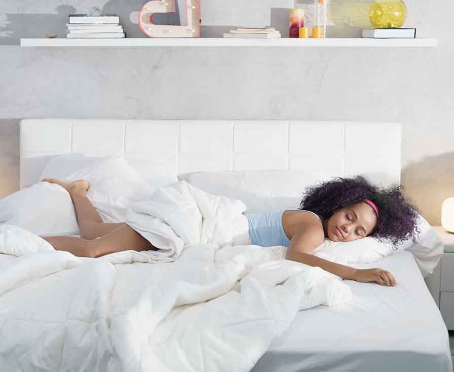 Black Woman Sleeping Alone in Large Bed