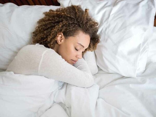 African American woman sleeping in bed