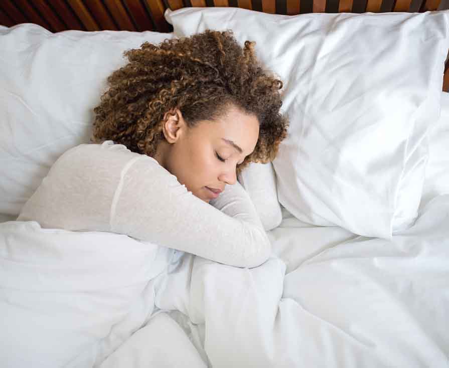 African American woman sleeping in bed