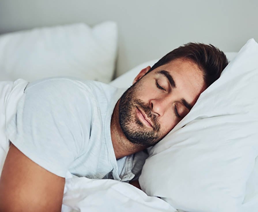 Man with beard sleeping in bed